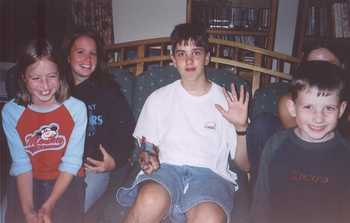 Matt between some of his cousins on his 15th birthday